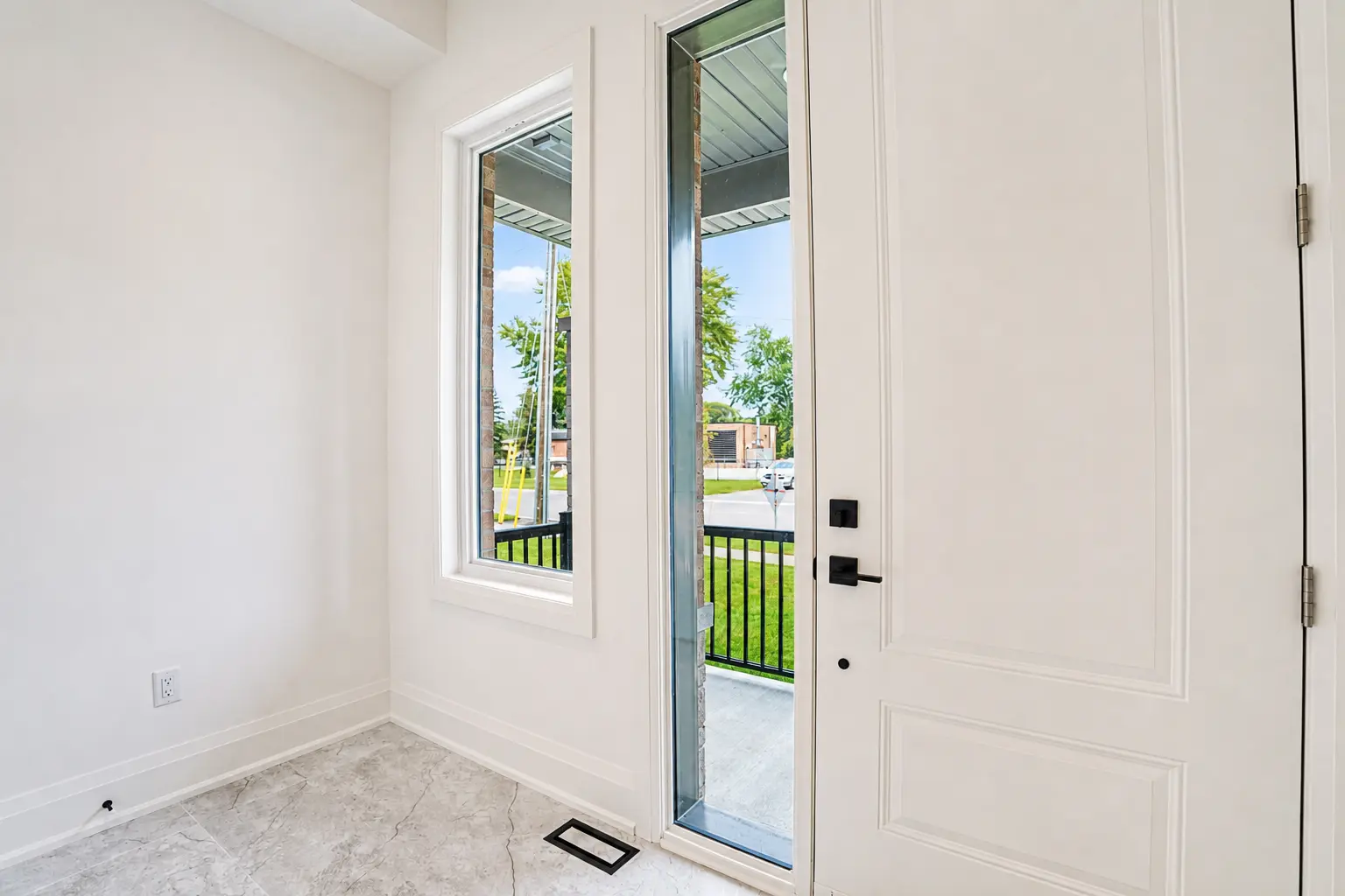 Front entry with glazed door, sidelight and marble-look tile floor