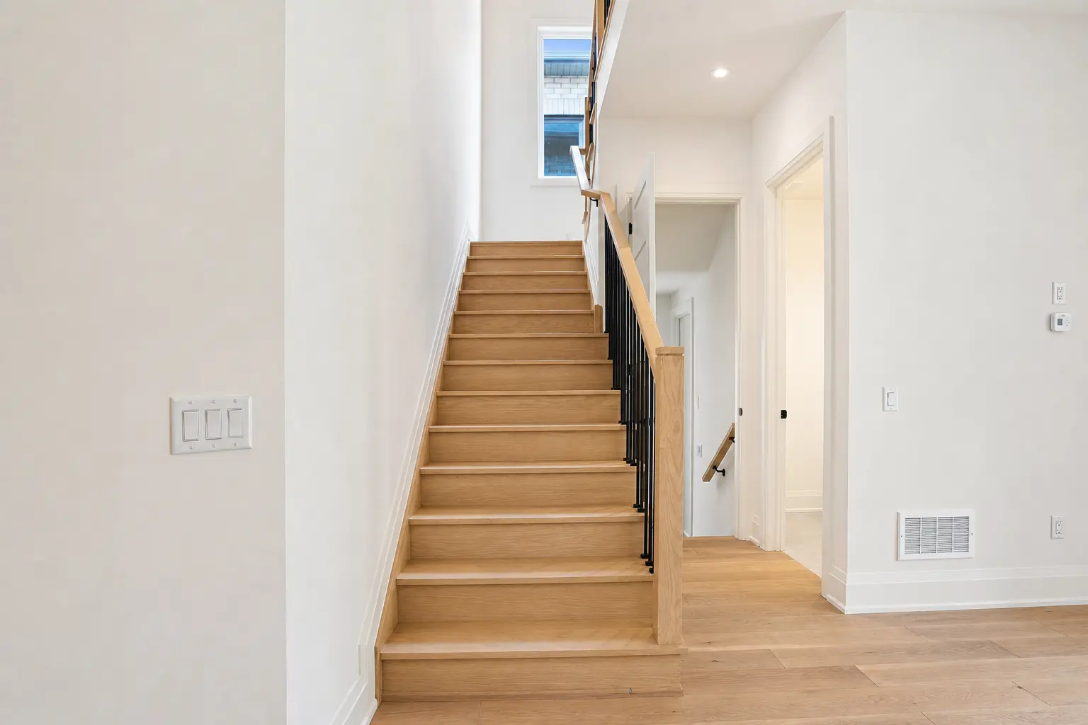 Oak staircase with iron spindles and stairwell window