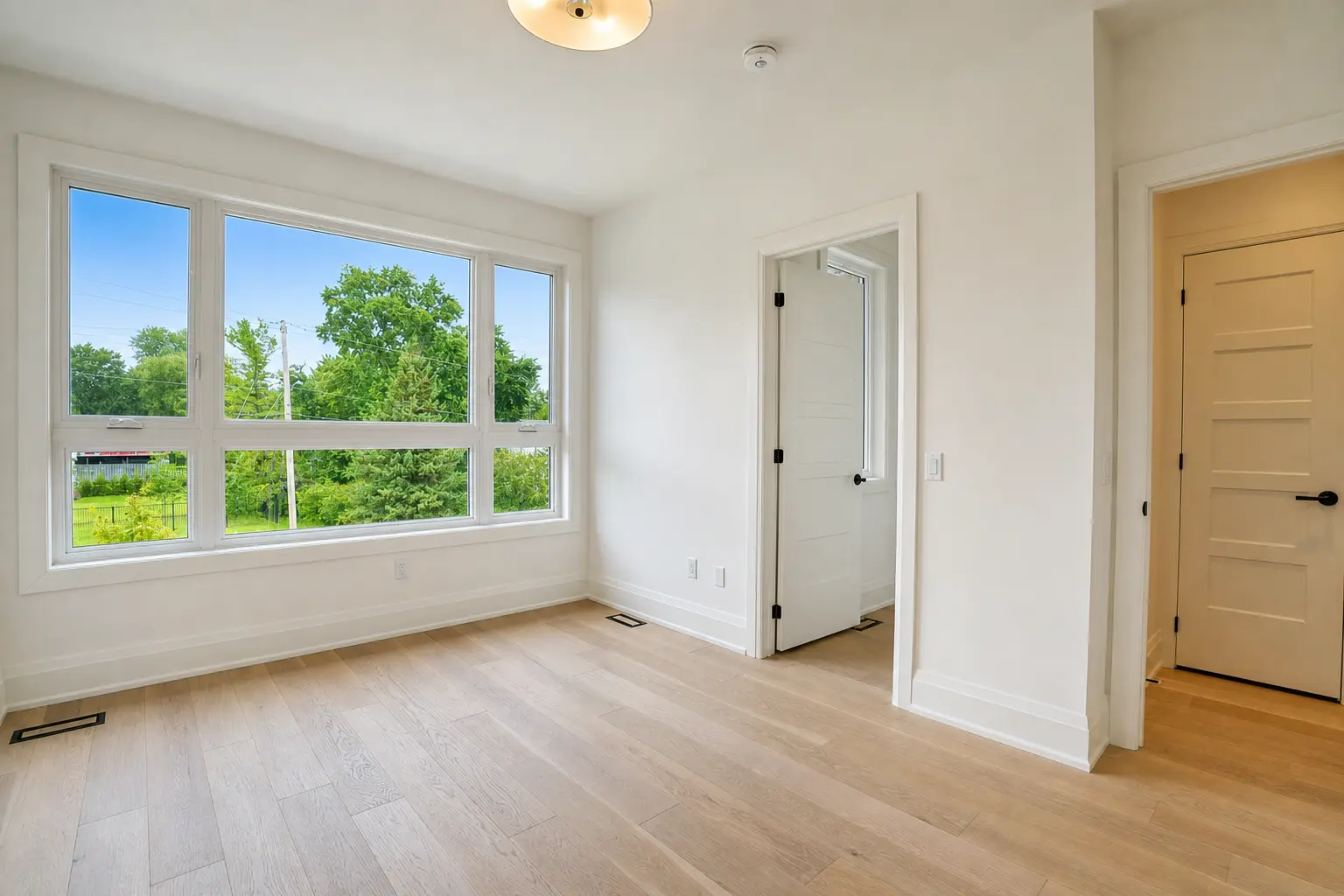 Bedroom with picture window, ensuite door and closet