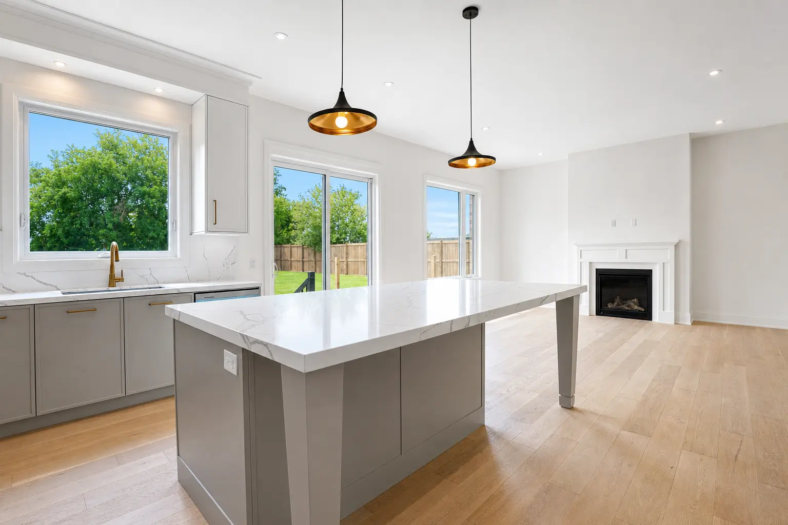 Quartz island with pendants looking through to the fireplace