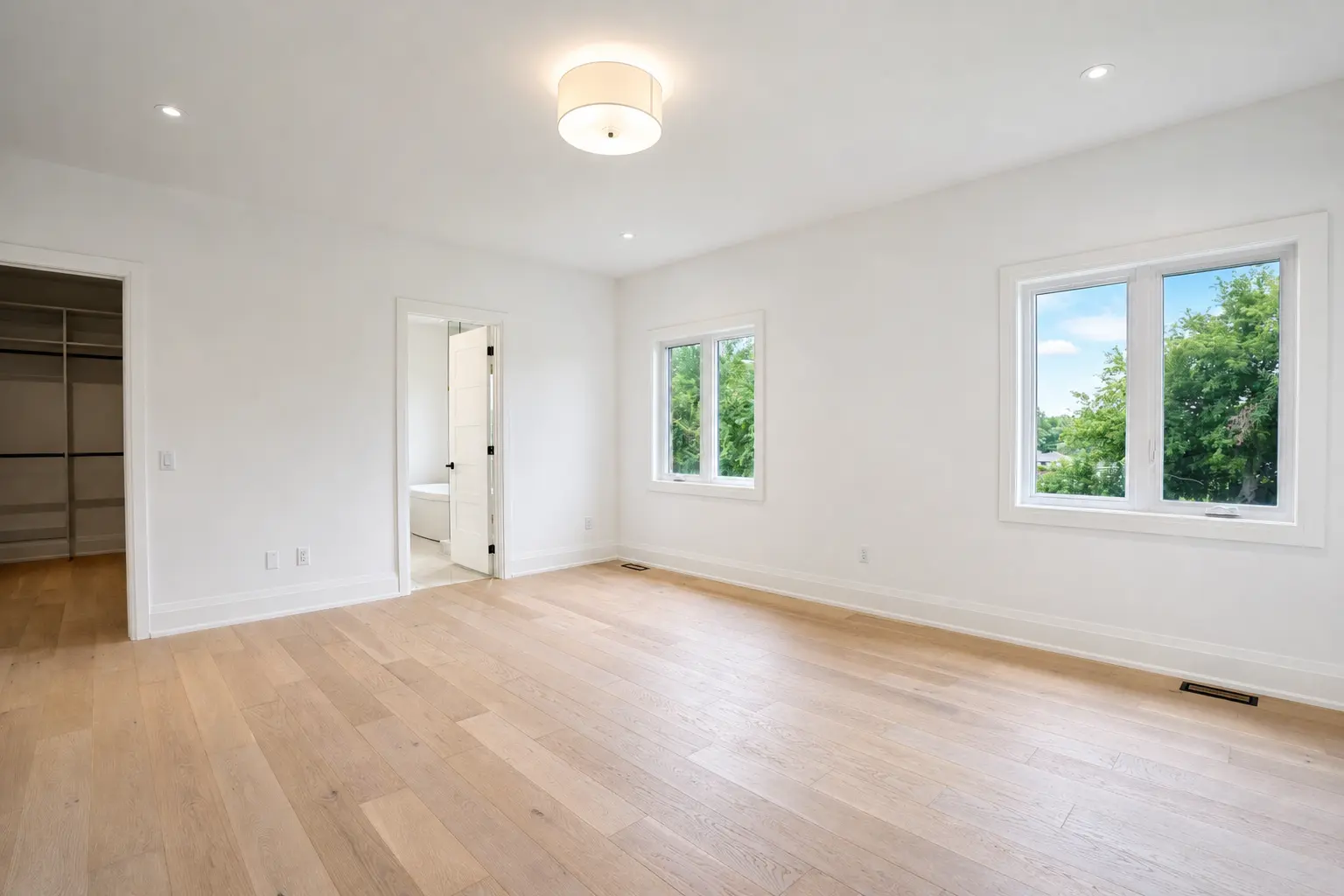 Primary bedroom with walk-in closet and ensuite access