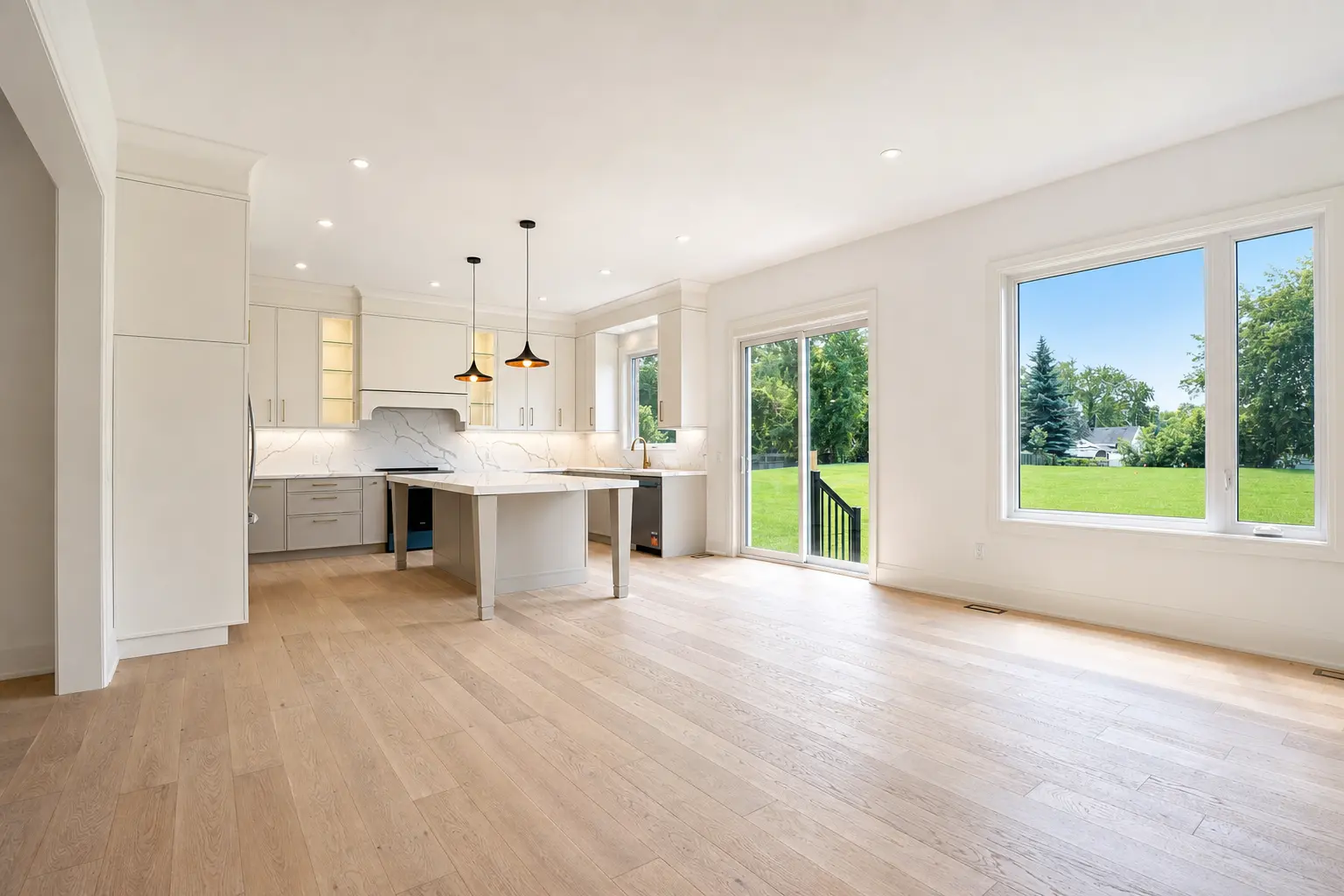 Kitchen open to the great room with sliding doors to the rear yard