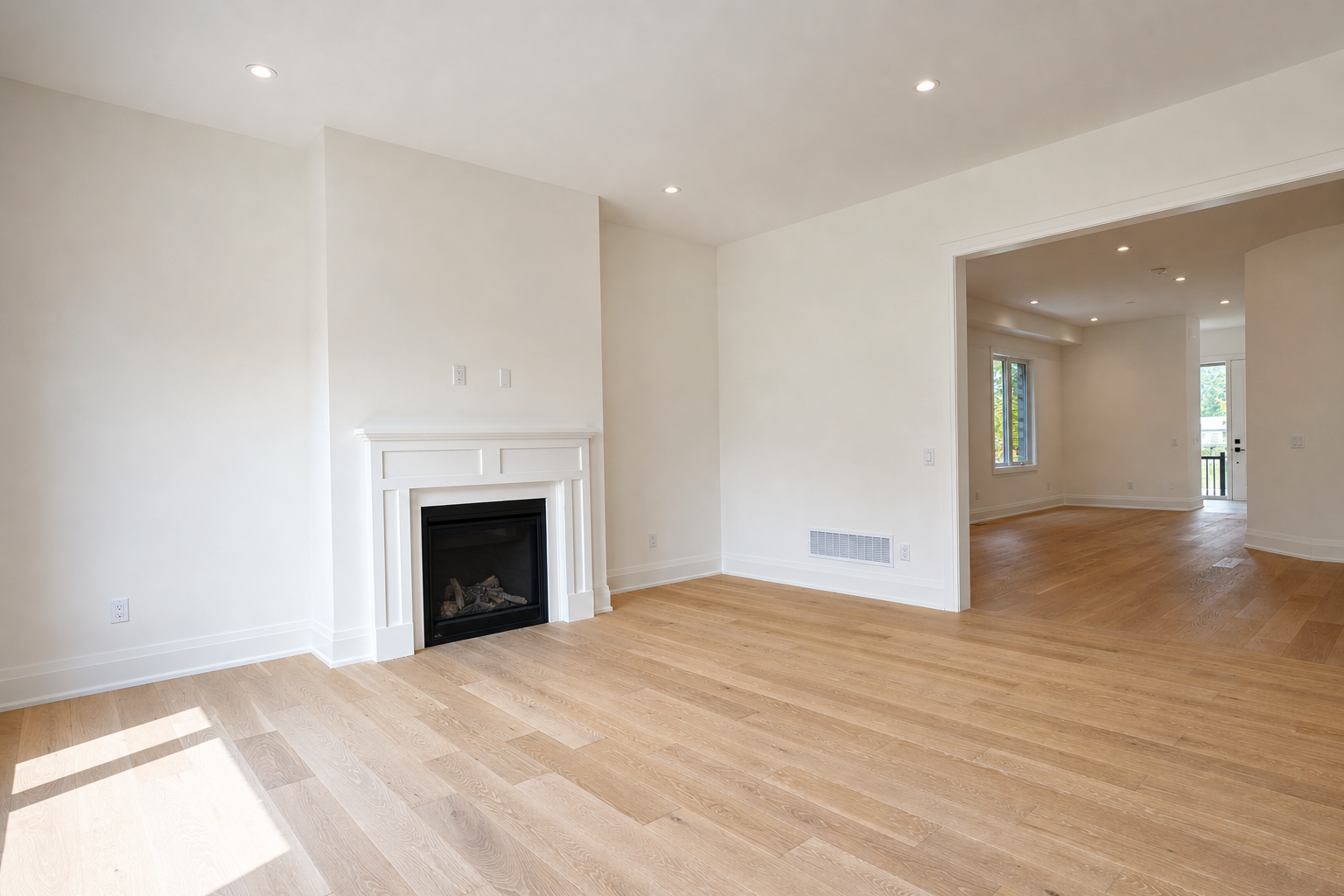 Great room with gas fireplace opening through to the dining area