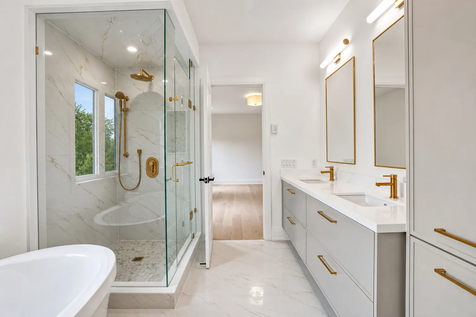 Primary ensuite with freestanding tub, glass marble shower and double vanity