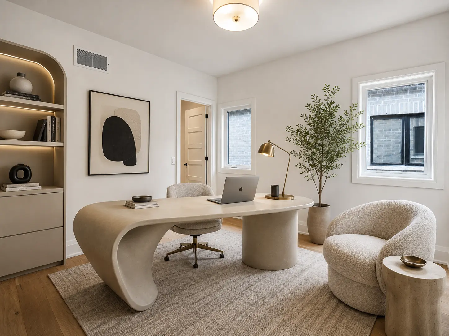 Staged home office with sculptural desk and arched built-in shelving