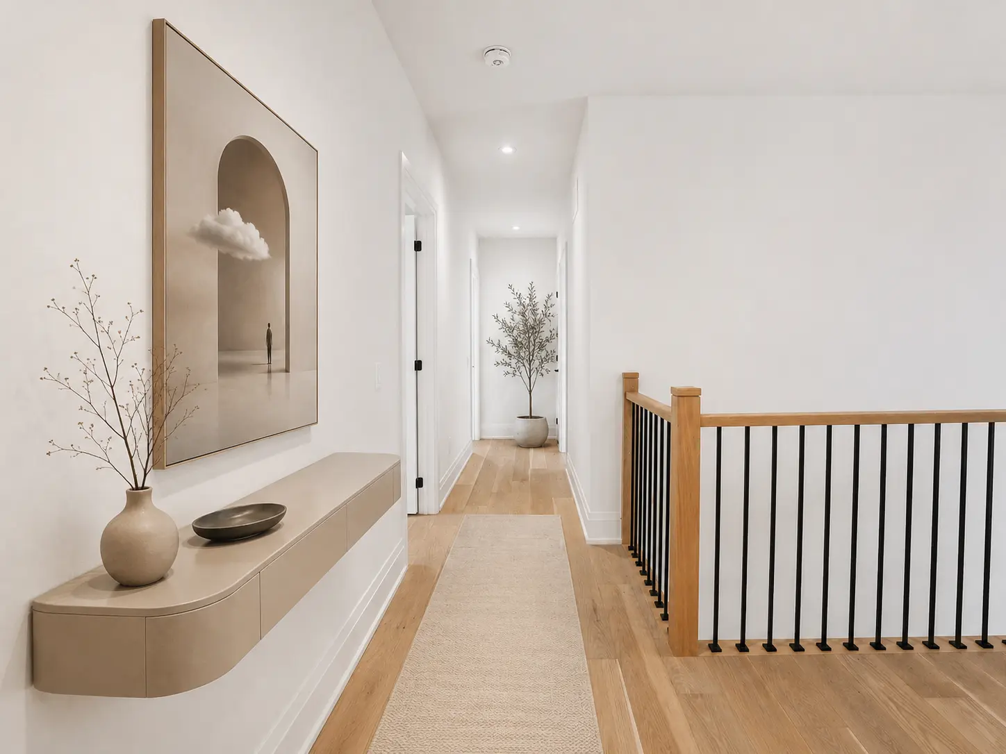 Staged upper hallway with oak railing, runner and floating console